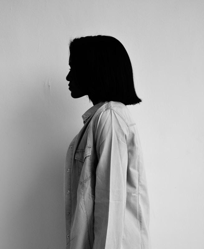 woman in white coat standing